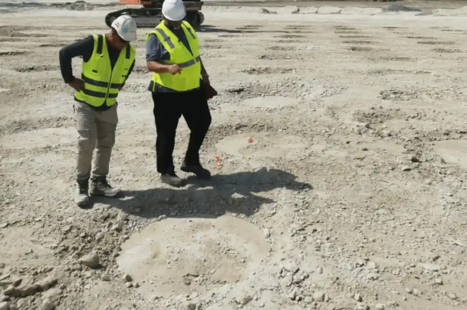 Geotechnical engineering consultant reviewing soil investigation reports on a construction site